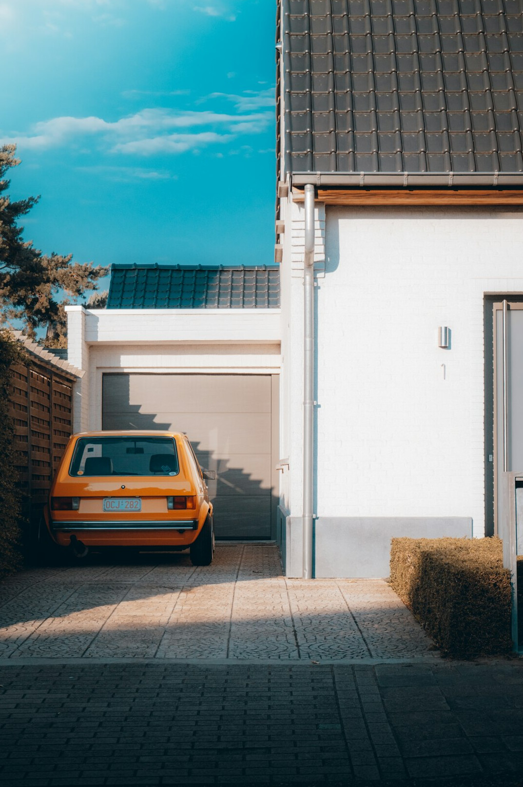 Car parked in front of a garage ready for a tire check