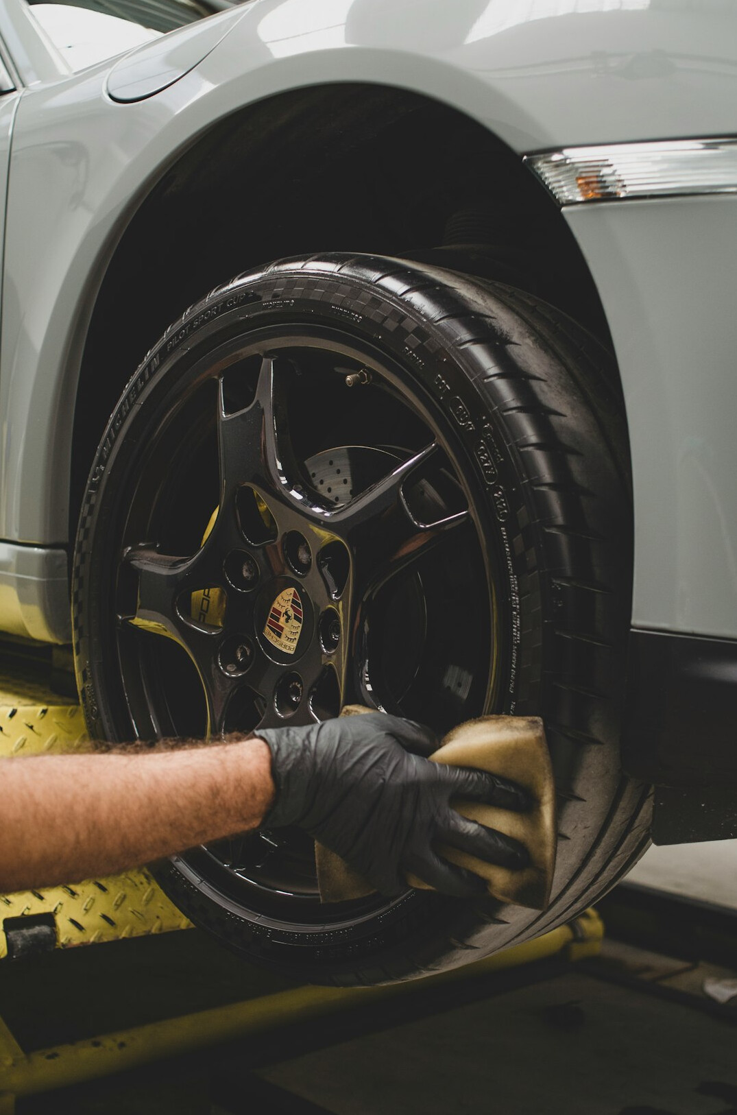 Mechanic checking a car tire in a garage
